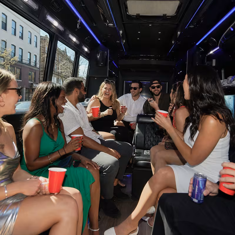 Party bus interior with wraparound leather seating and LED lighting in Morristown