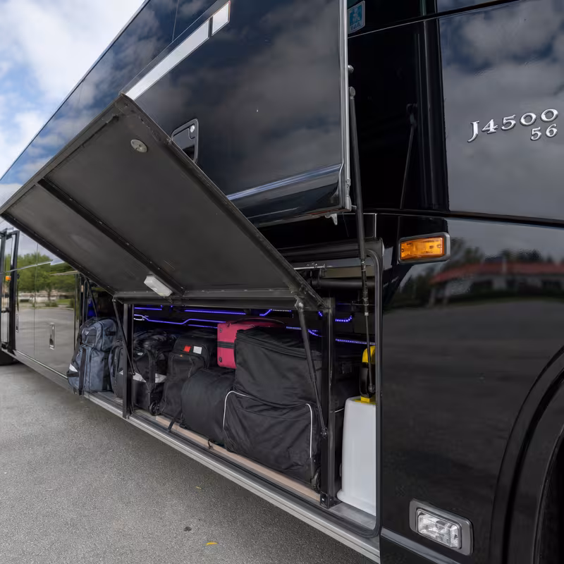 Party bus interior with wraparound leather seating and LED lighting in Morristown