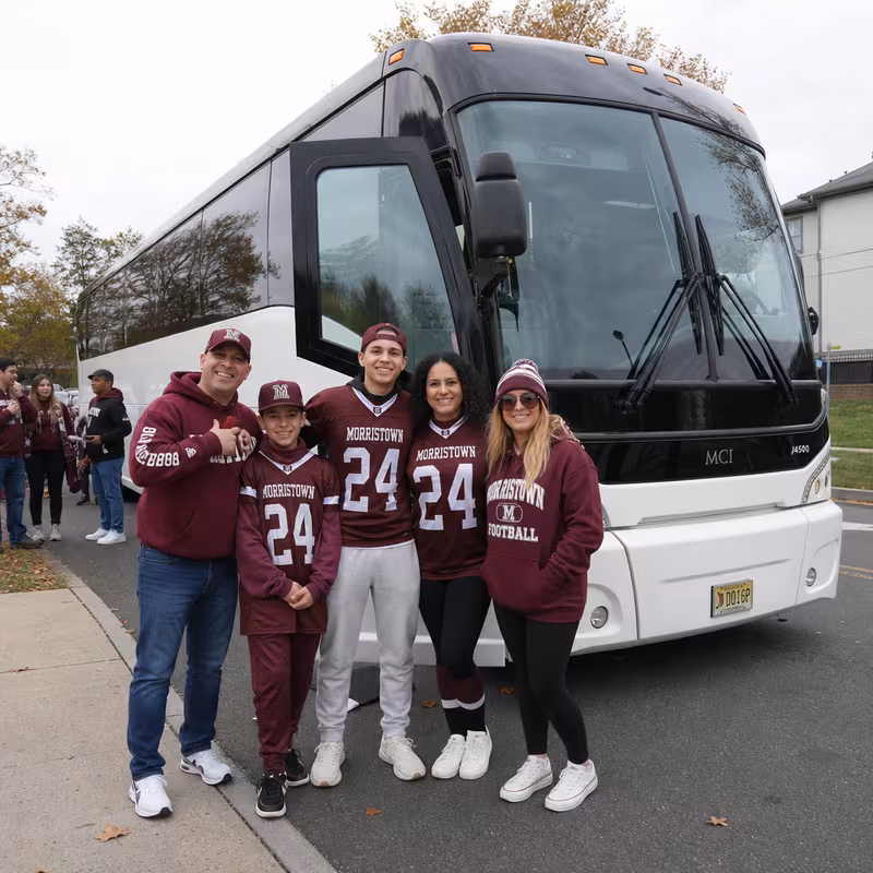 Passengers loading luggage while boarding an Morristown group shuttle