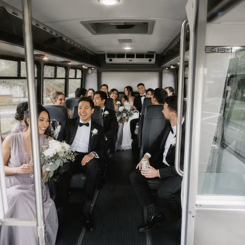 Group boarding a white charter bus for Wedding Transportation transportation in Morristown