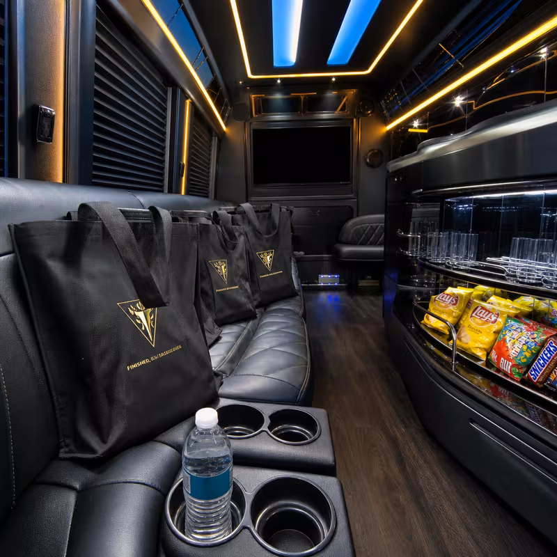 Party bus interior with wraparound leather seating and LED lighting in Morristown